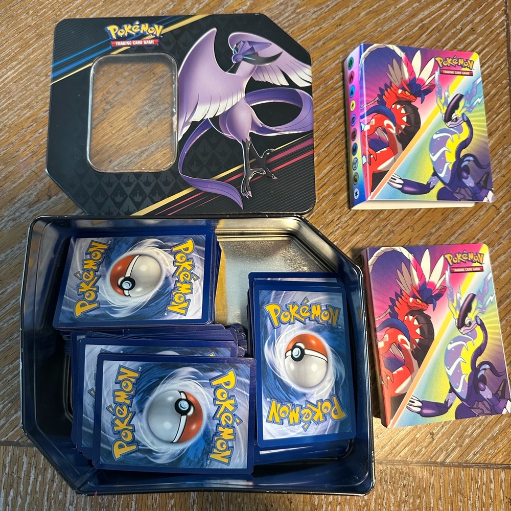 200 pokemon cards, 2 small binders 30 sleeves 2 sided, 1 tin box